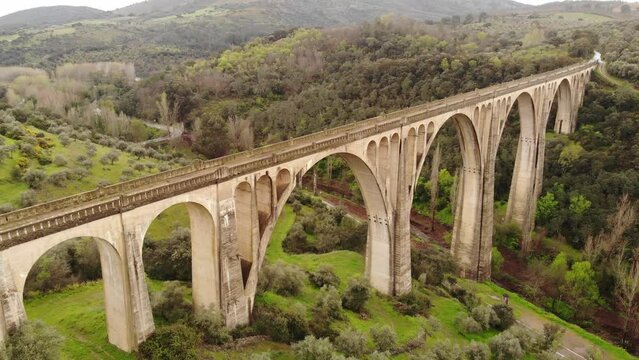 View of grand structure of arched viaduct located in picturesque area near Spanish township of Guadalupe in Extremadura community on spring day