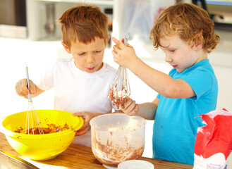 Baking, kids and learning in kitchen in home for development of siblings making chocolate pastry. Children, brothers and mixing dough, flour and cooking food at table together for education in house