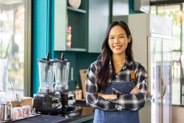 Portrait of asian barista woman small business owner working behind the counter bar and  receive order from customer on coffee packaging and cup of coffee background in cafe or coffee shop