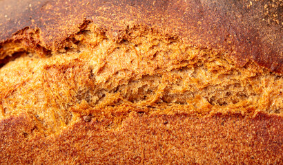 Ruddy crust of bread as an abstract background. Texture - 784977868