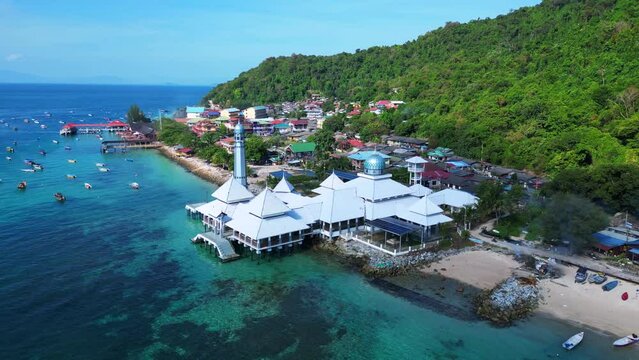 Islamic white mosque at beach on Perhentian Island. Nice aerial top view flight 
overflight flyover drone
4k
