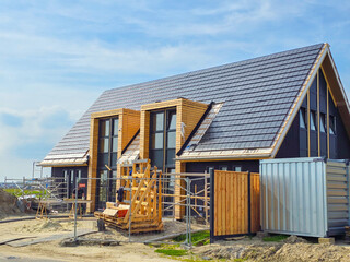 construction site of a new Dutch Suburban area with modern family houses, newly built modern family...
