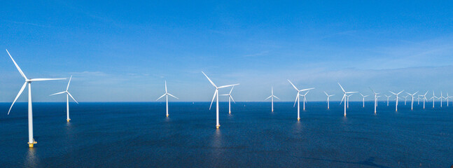 offshore windmill park and a blue sky, windmill park in the ocean. Netherlands Europe. windmill turbines in the Noordoostpolder Flevoland