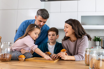 Fototapeta premium In the cozy kitchen, a family gathers around the table. With smiles on their faces enjoying the simple pleasures of togetherness and sweetness in every bite.