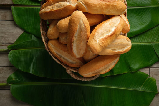 Bread rolls in basket on palm leaf