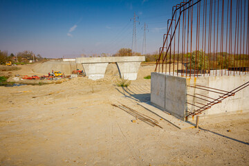 Concrete armature pillar at building site. Construction of concreting reinforced bridge poles