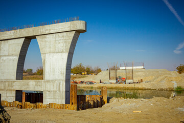 Huge pole in foundation with metal piles, construction of concrete-reinforced bridge pillars at...