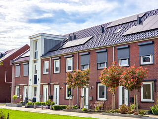 Newly built houses with black solar panels on the roof in the Netherlands