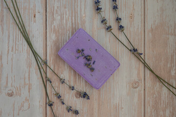 Handmade aromatic spa lavender soap. Natural additives and extracts. Bar of lavender soap with dried flowers. Beauty treatment product herbal ecological organic cosmetics