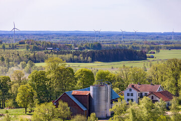 Rural landscape view with a farm and wind turbines