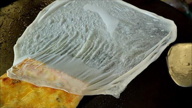 Footage of Chef Cooking Murtabak or Roti Mataba on the Iron Pan