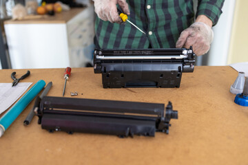 Toner replacements in printer cartridge. Printer service concept. Disassembly of the printer cartridge for its maintenance and refilling with toner. 