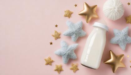 Top view photo of knitted stars toy milk bottle and gold stars on isolated pastel pink background with copyspace