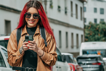 Obraz premium young woman with leather jacket and phone on the street