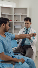 Obraz premium Physical therapist helping a patient while stretching his legs on a bed in a clinic or hospital. Young man attends a physiotherapy course on muscle weakness pain. and heel pain with elastic