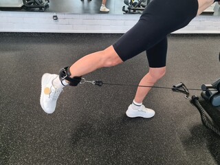 Woman Pulling Rope in Gym