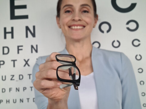 Woman Holding Up a Pair of Glasses