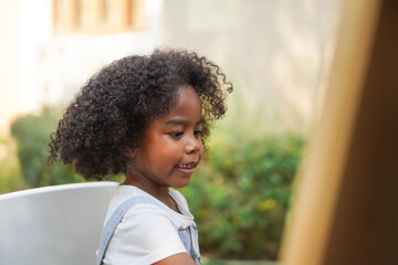Portrait happy african american cute girl smiling face looking at camera at home, kid, child, young adorable, student, elementary school and education concept