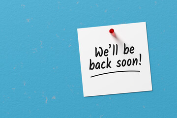 The message we will be back soon written on a note paper
