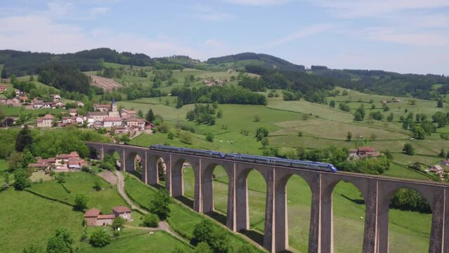 Drone footage of a train on Mussy-sous-Dun Viaduct entering Mussy-sous-Dun village, France