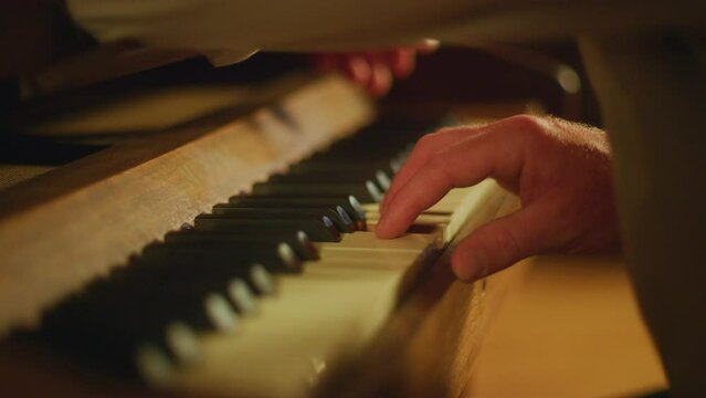 Close up fingers playing the piano keys