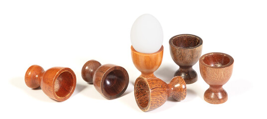 Wooden eggcups isolated on white background - 785040204