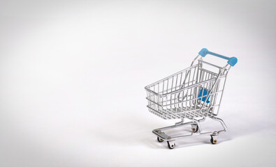 Small shopping cart isolated on solid background