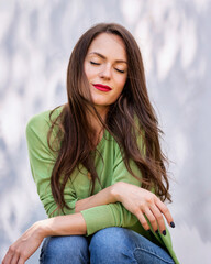 Outdoor portrait of young woman with closed eyes and red lipstick - 785042469