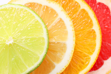 Slices of fresh ripe citrus fruits as background, top view