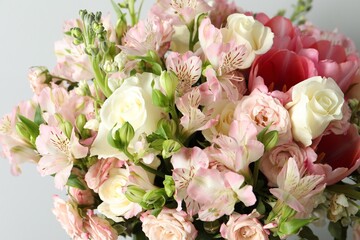 Beautiful bouquet of fresh flowers on light background, closeup