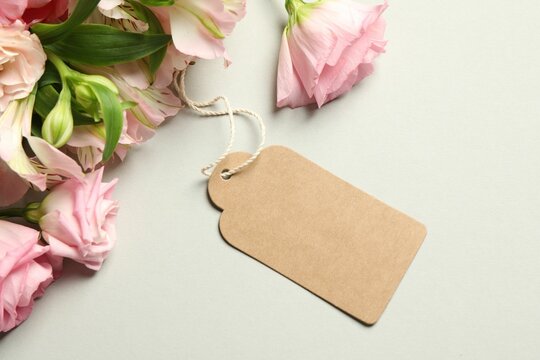 Happy Mother's Day. Beautiful flowers with blank card on light background, flat lay
