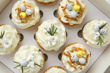 Tasty Easter cupcakes in box, top view