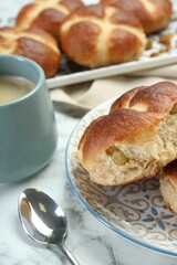 Hot cross buns served on white marble table, closeup