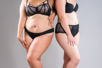 Tummy tuck, two overweight fat women with cellulitis and flabby bellies on gray background, obese female body, liposuction and plastic surgery concept