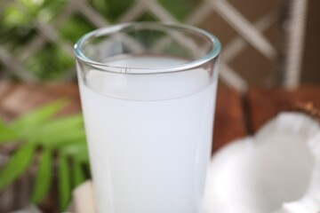 Glass of coconut water on table, closeup