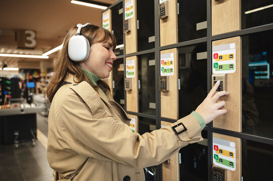 Smiling woman entering password on storage locker at supermarket