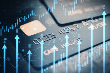 Close up of bank card with growing blue vertical arrows and candlestick forex chart on blurry index...