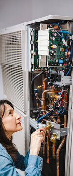 Air conditioner technician servicing AC unit