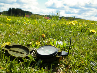 Compass on the meadow - travel and vacations concept.