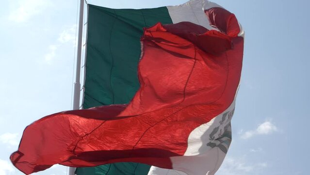 Wrinkled color washed waving Mexican flag moving with the wind in slow motion. Mexico Flag