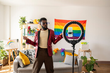 Young non-binary person dancing and vlogging at home