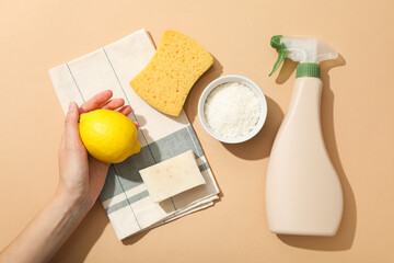 Towel, hand, sponge and ingredients for natural detergent on beige background, top view