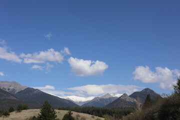 a high angle shot of a mountain landscape with a cloudy sky