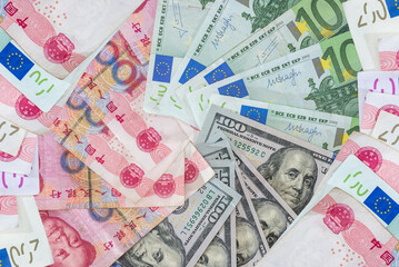 Fototapeta na wymiar US dollar and Euro, yuan banknotes as background