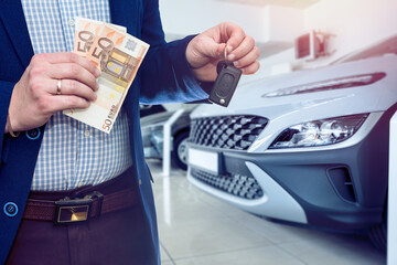 Man hold euro money in car showroom. Concept of buy or rent new car - obrazy, fototapety, plakaty