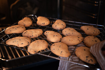 Freshly baked cookies in oven. Homemade food - 785082820