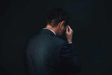 Rear view of sad depressed businessman