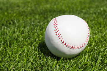 Game ball for playing baseball on green grass