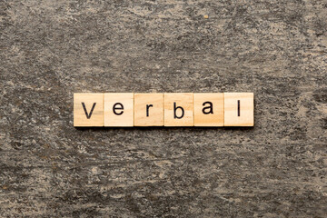 verbal word written on wood block. verbal text on table, concept