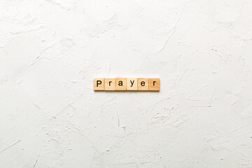 PRAYER word written on wood block. PRAYER text on cement table for your desing, concept